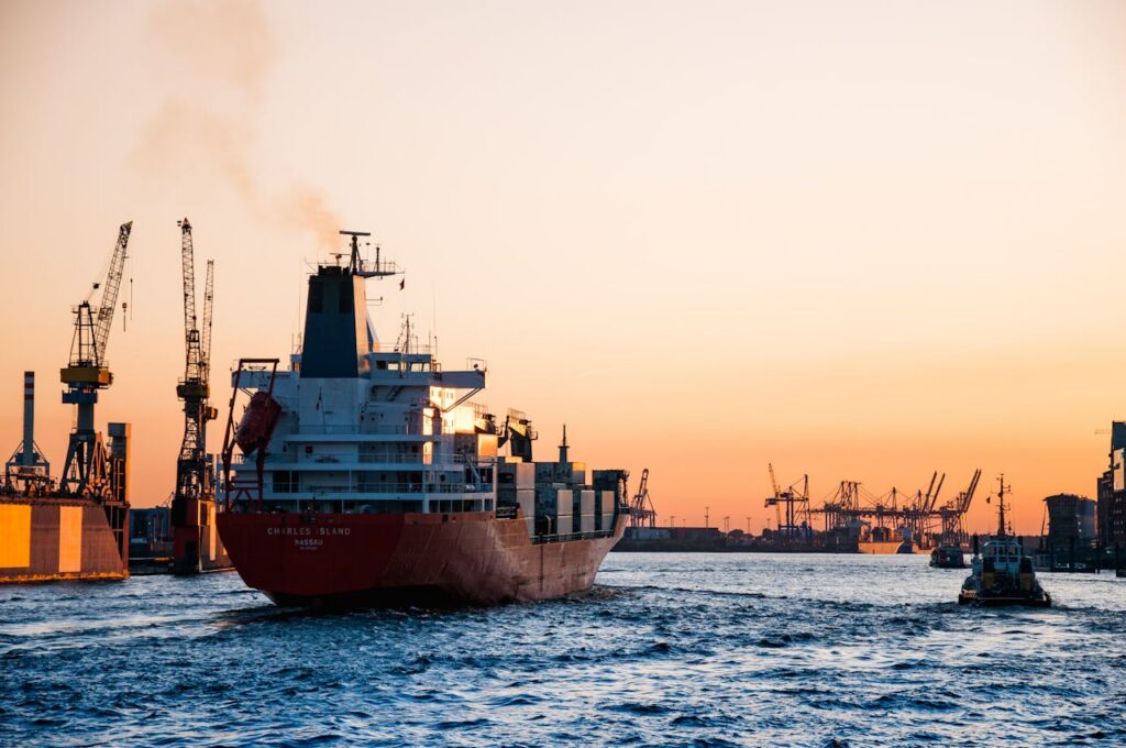 pexels-photo-799091 Stunning sunset view of cargo ships and cranes at the Port of Hamburg, epitomizing global trade and logistics.